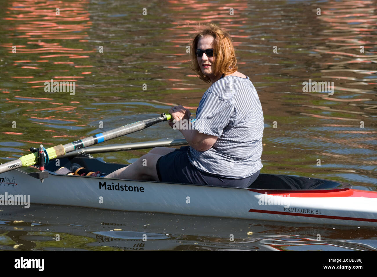 row rowing scull oars canoeist middle aged woman Stock Photo Alamy