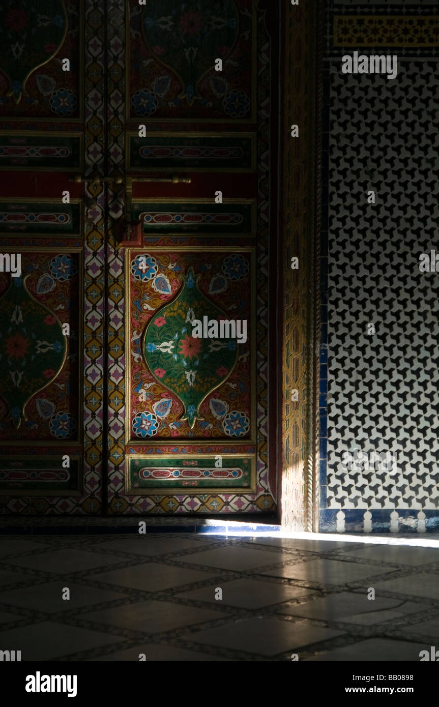 Shaft of sunlight on beautiful painted ornate doors and mosaic walls at Riad Mokri - now a music school. Stock Photo