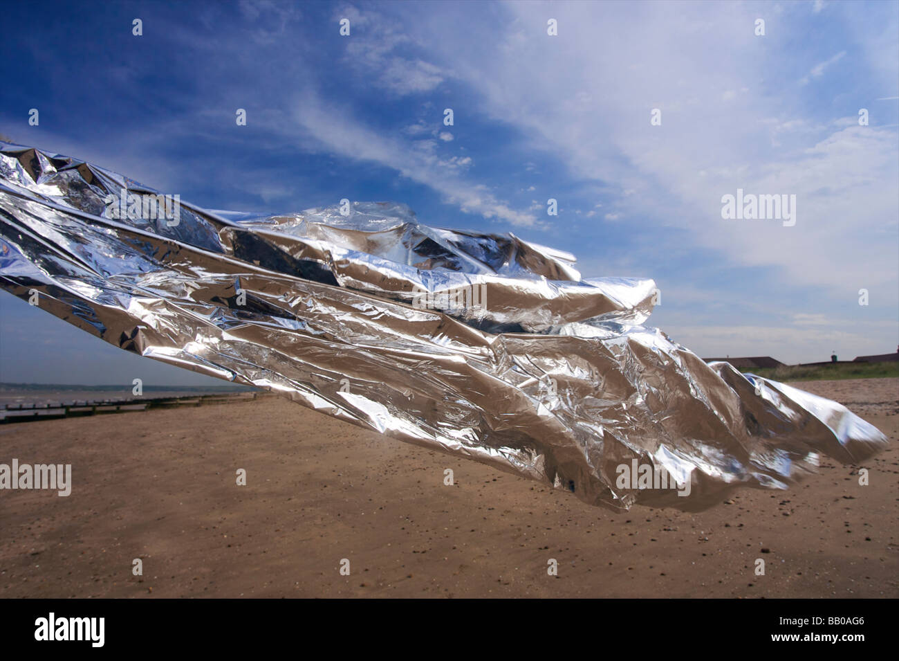 Silver (emergancy survival blanket) blowing in the wind, flowing with cloud formation Stock Photo