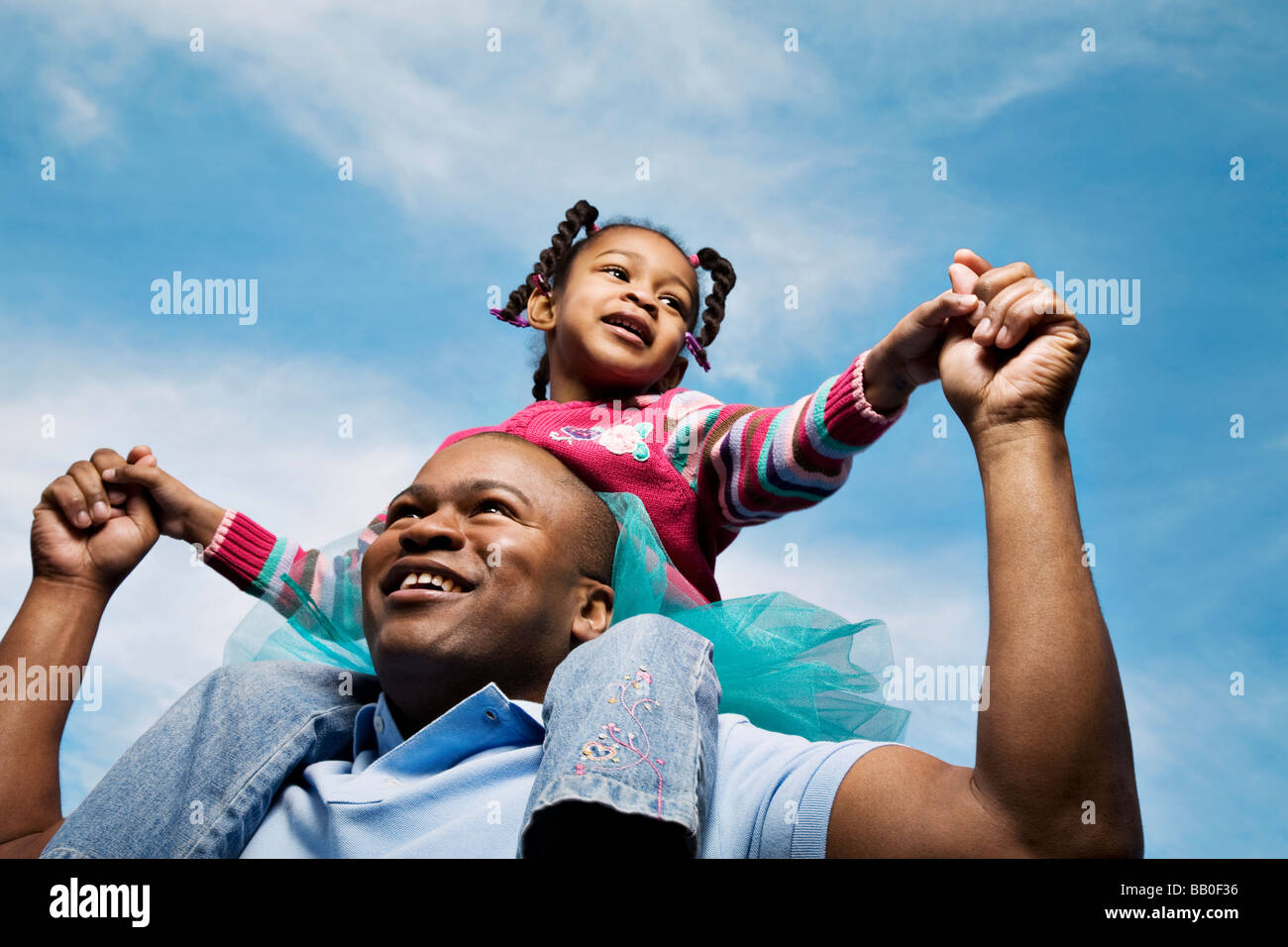 African father carrying daughter on shoulders Stock Photo - Alamy
