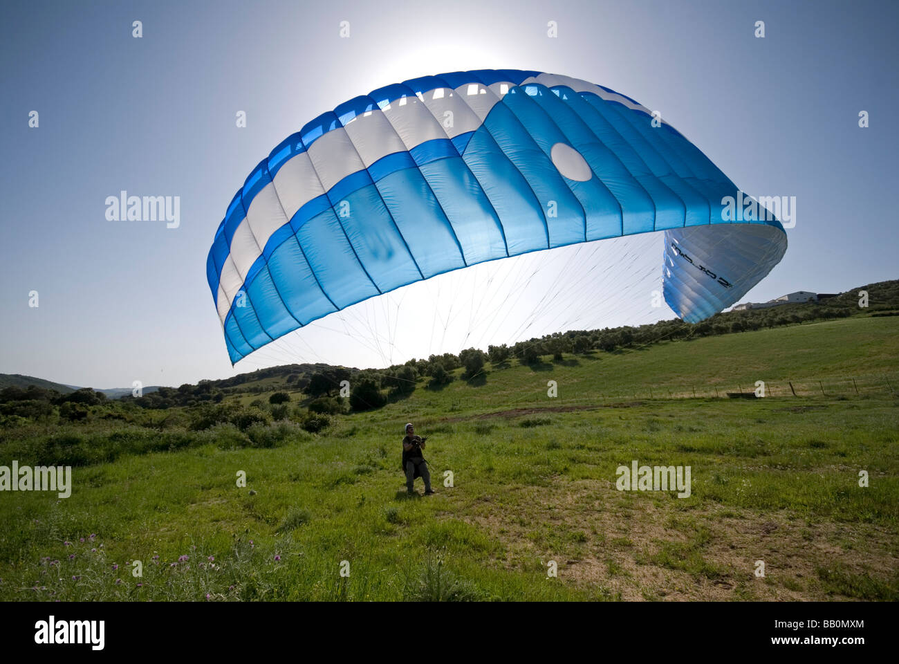 Para glider pilot practicing ground handling on landing site Stock Photo