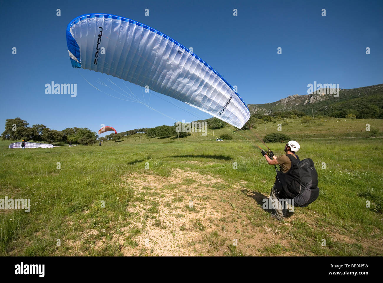 Para glider pilot practicing ground handling on landing site Stock