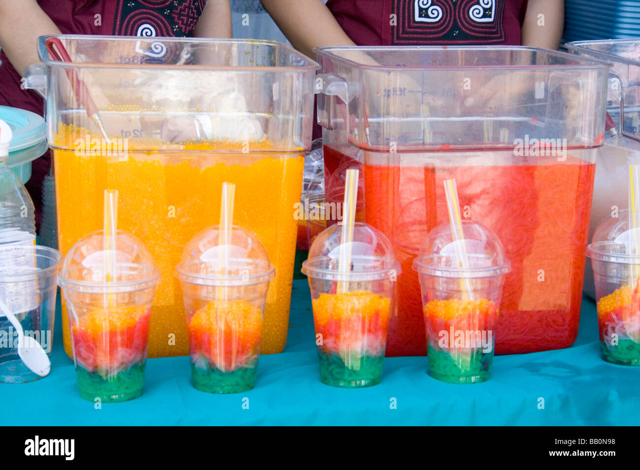 Hmong festival concession stand serving multicolored fruit drinks