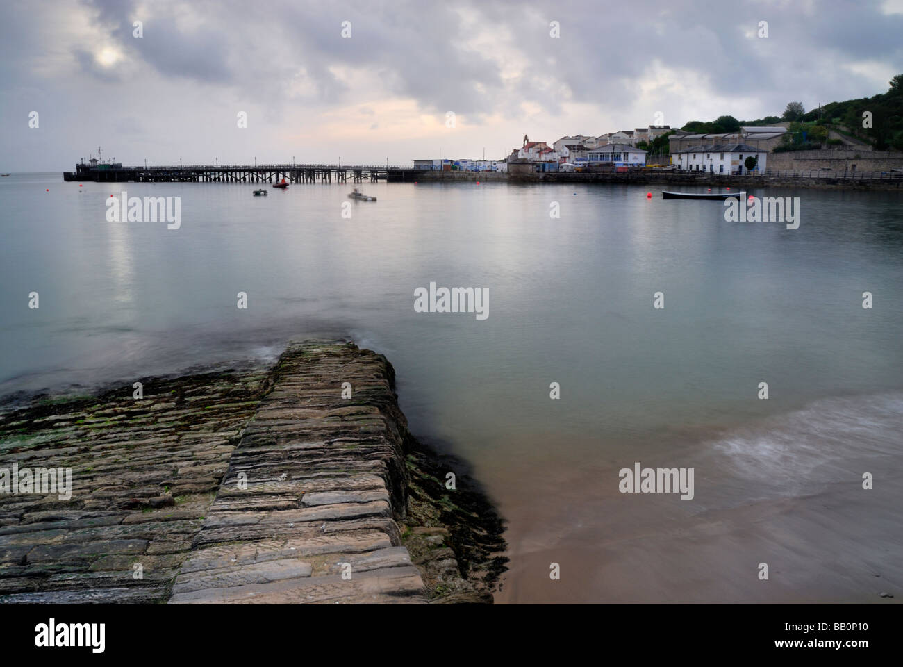 Brick jetty in foreground swanage Pier in background. Swanage Bay ...