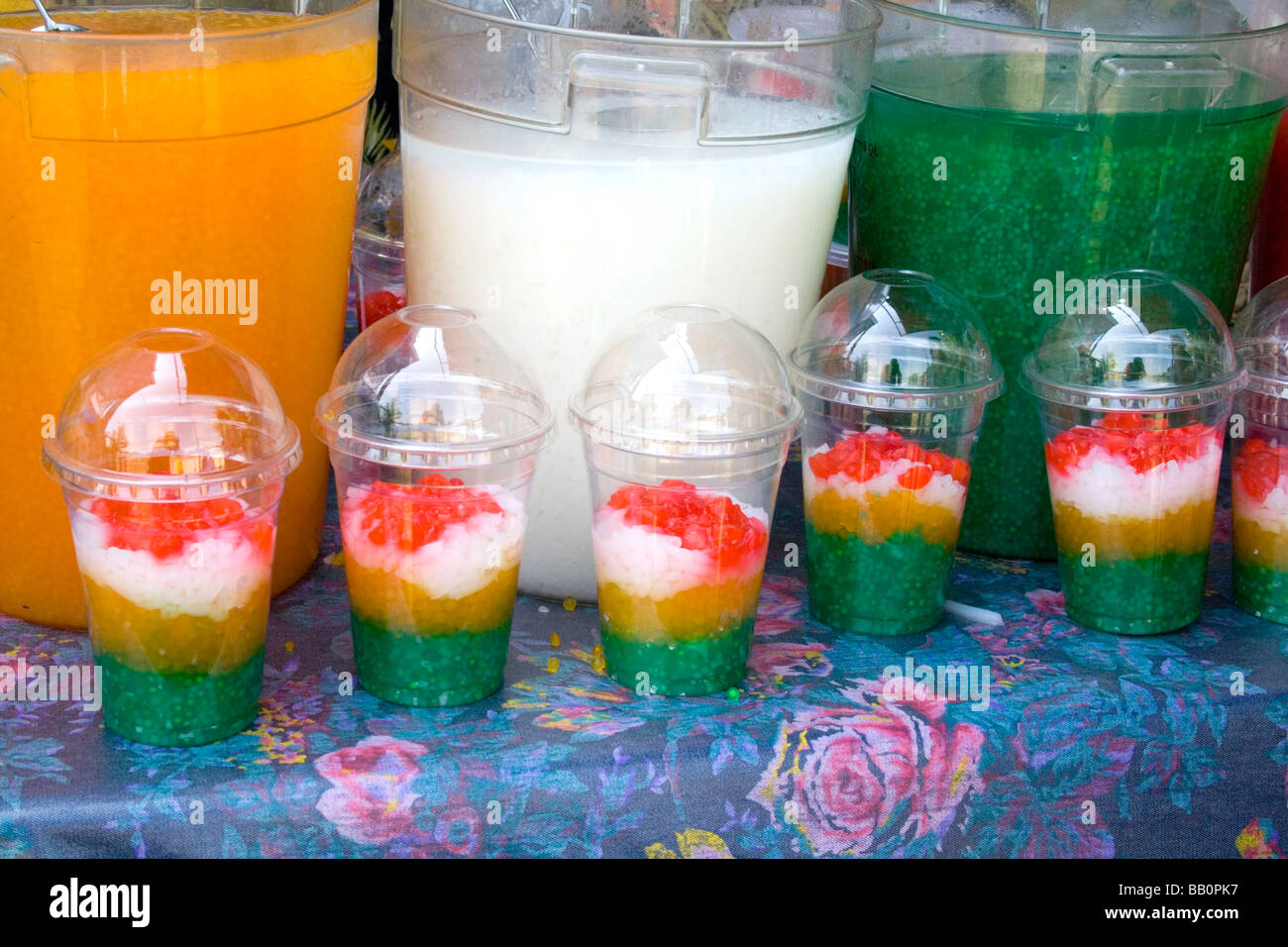 Hmong festival concession stand serving multicolored fruit drinks