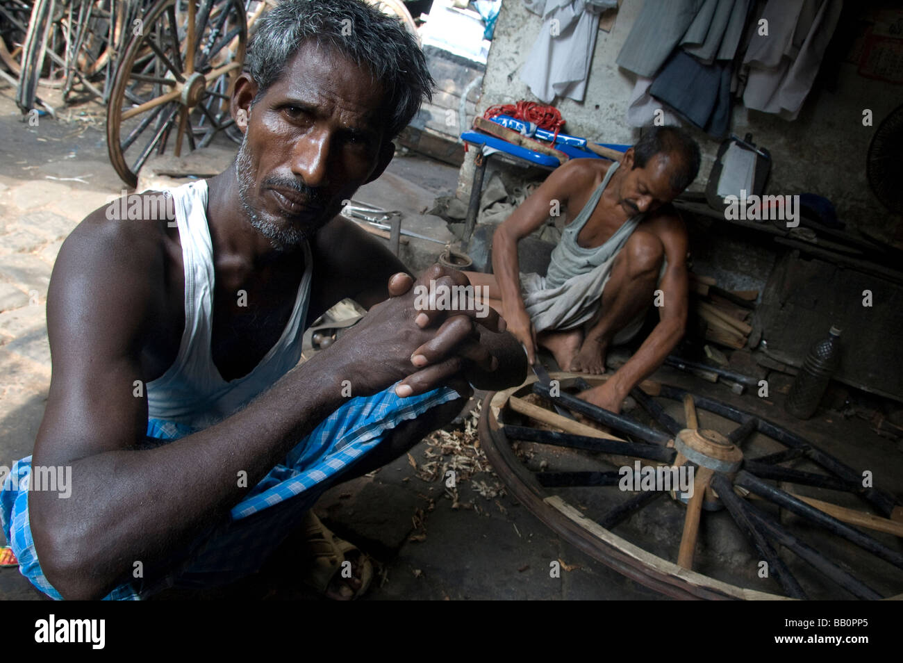 Rickshaw puller in a garage in Kolkata (Calcutta), India Stock Photo