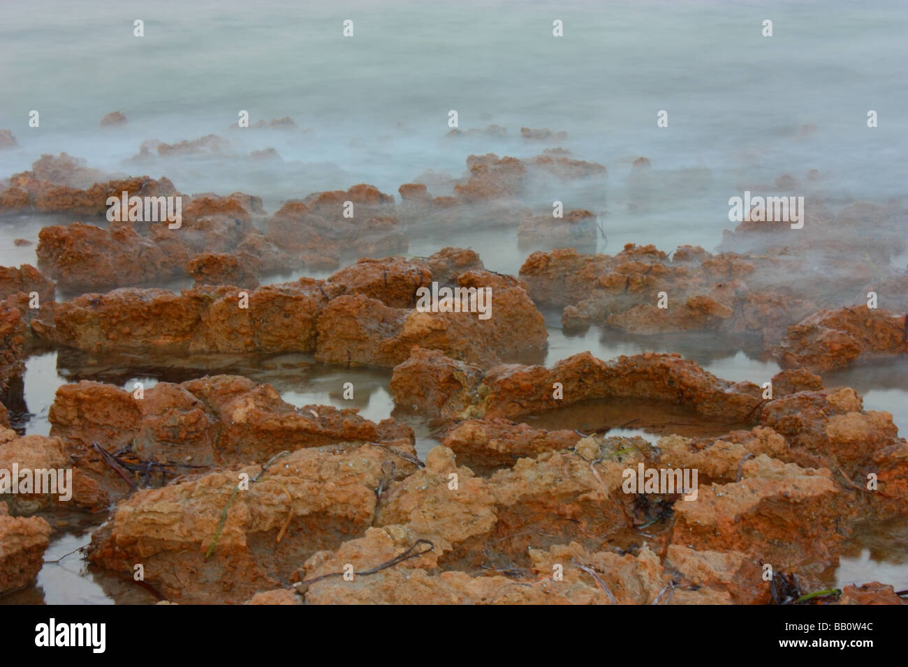 Stones with seawater washing through in south Australia Stock Photo
