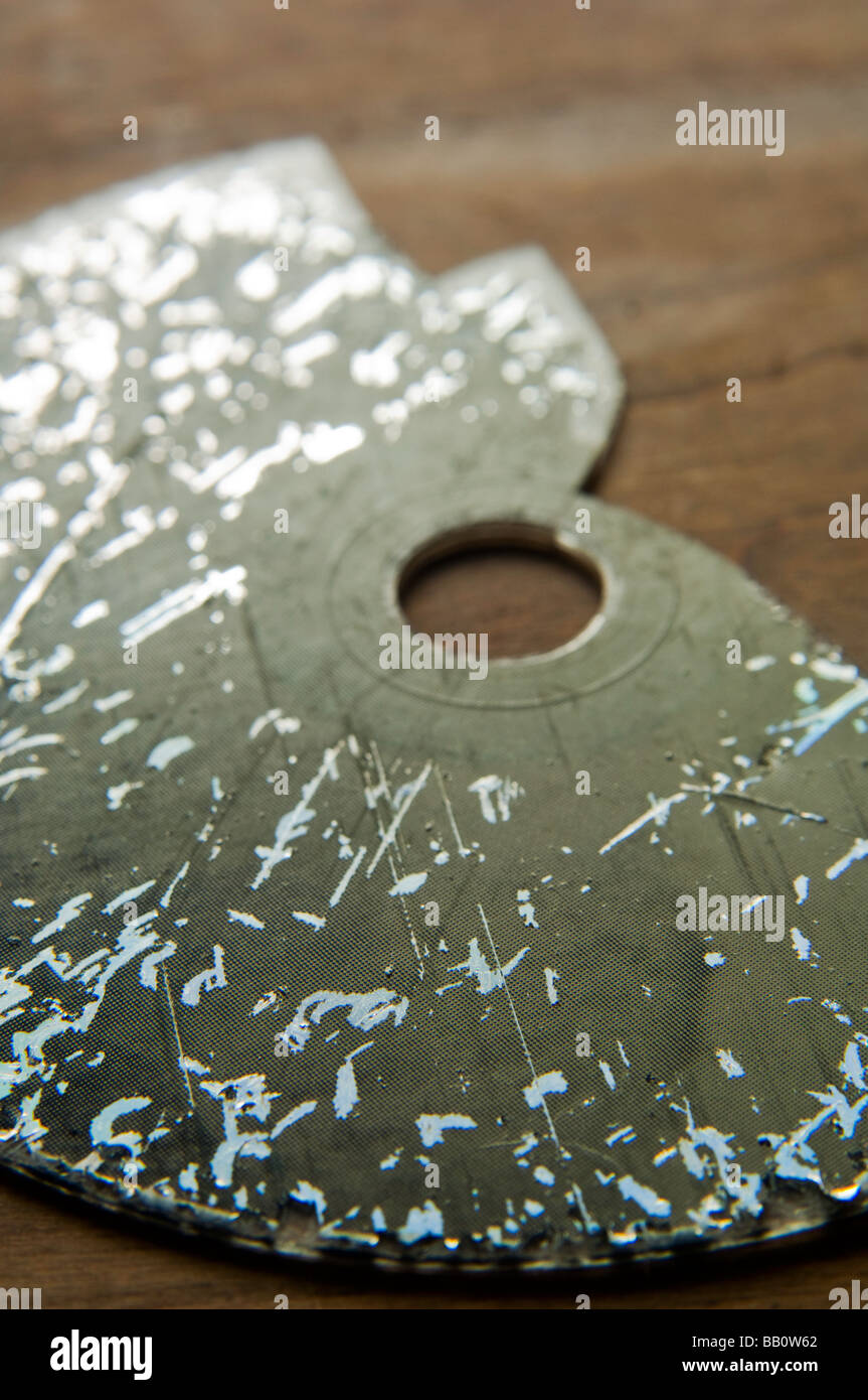 Battered and broken compact disc Stock Photo