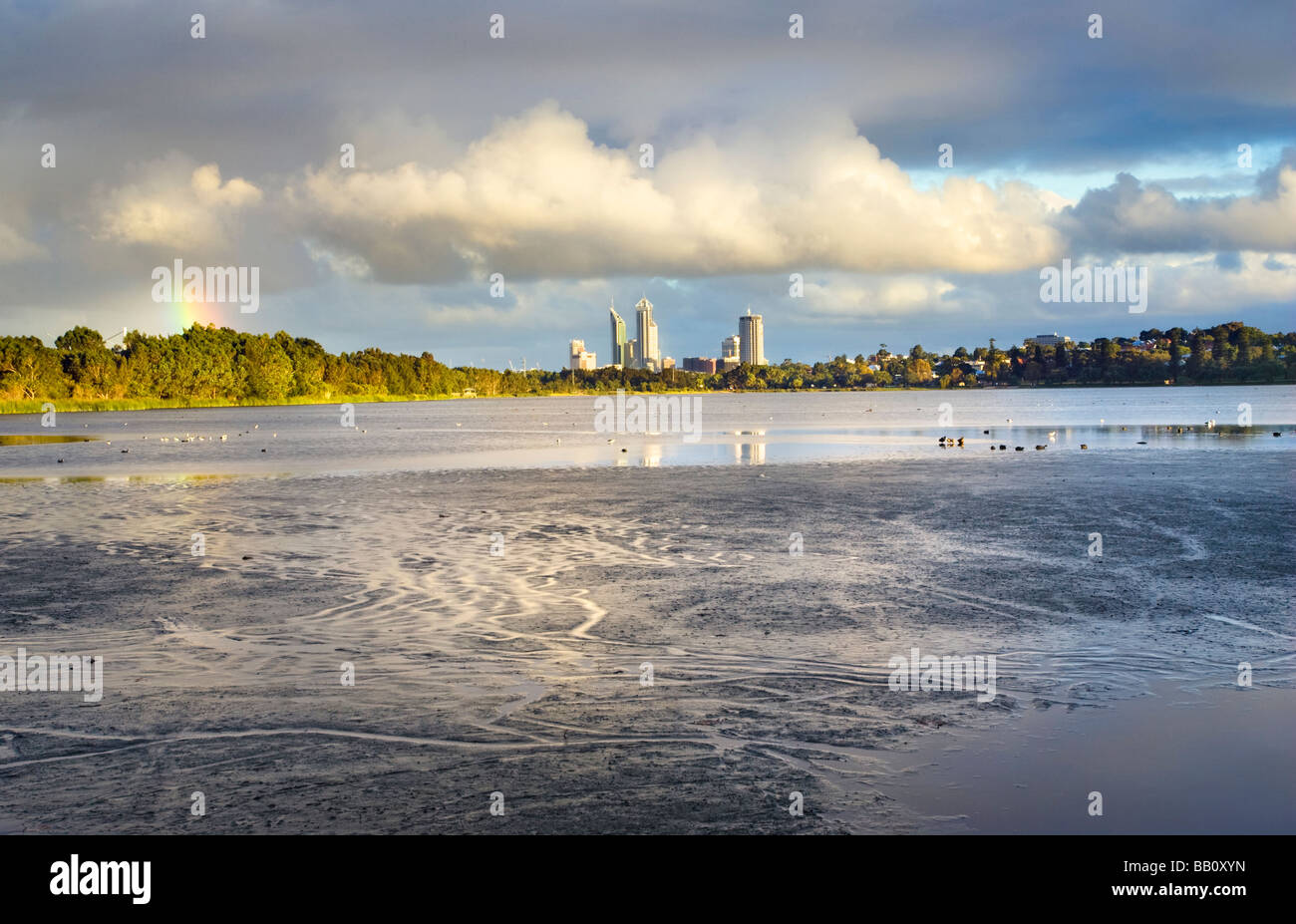 After weeks without rain, rain clouds and a rainbow form over a dry
