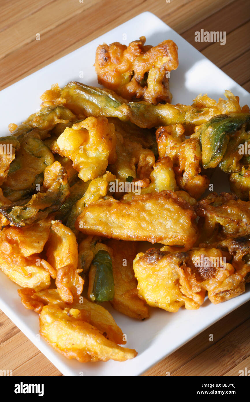 Vegetable Fritters is a snack which is made from vegetables dipped in a gram flour batter and