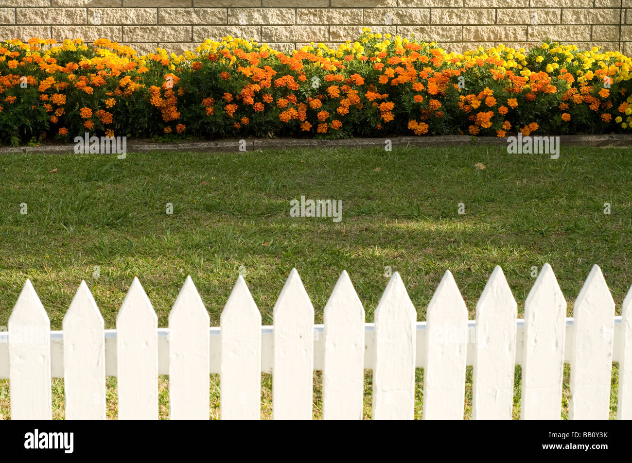 white picket fence with flower bed Stock Photo