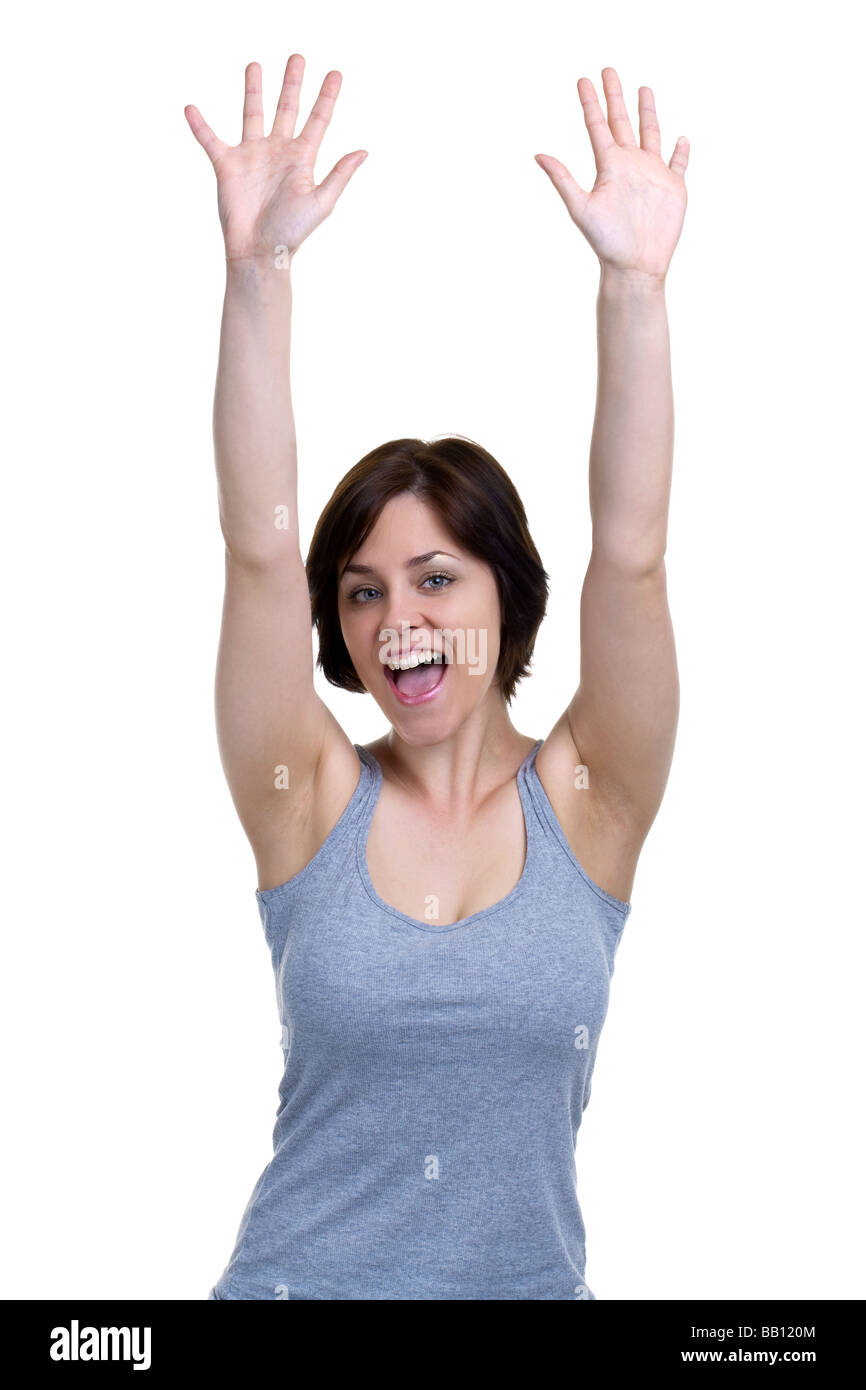 Brunette woman cheering with her hands in the air isolated on white background Stock Photo