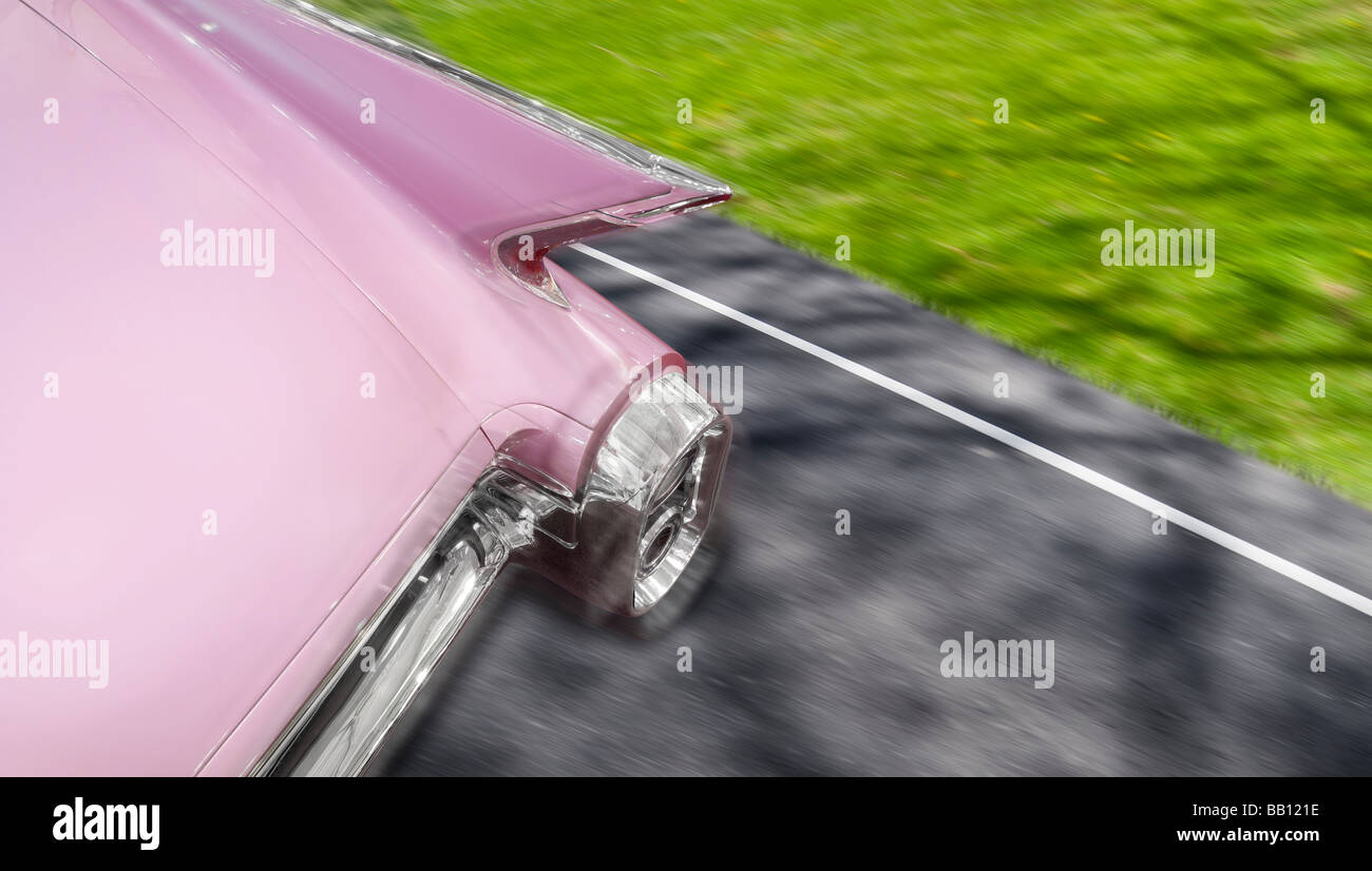 Pink Cadillac 1959 Fleetwood Car Detail of Rear Fins While Driving On Road With Motion Blur, Michigan USA Stock Photo