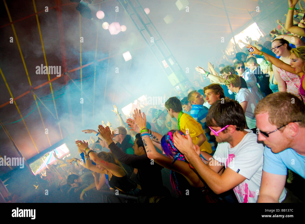 Festival crowd inside tented dance stage Stock Photo