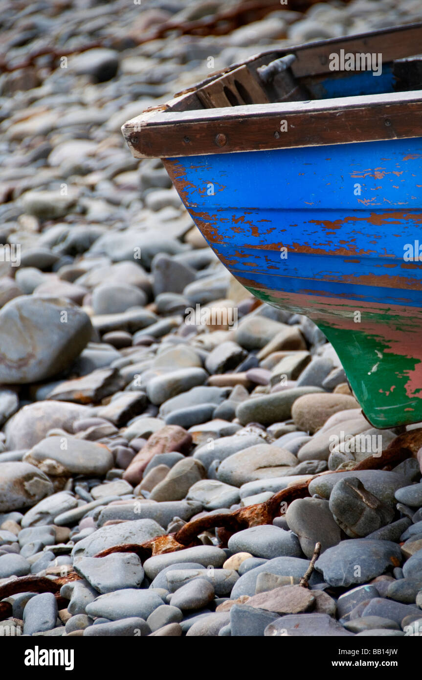 Detail of an old boat moored on a pebble beach in Clovelly, Devon, UK Stock Photo