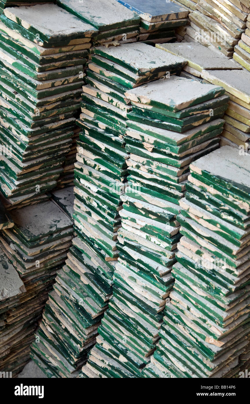 Piles of hand made ceramic tiles, stored ready to be cut up for mosaics. Used on tables, walls, fountains, details Stock Photo
