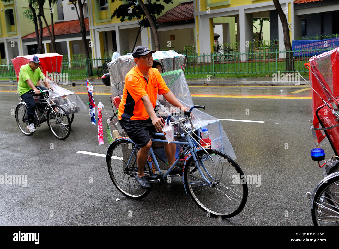 Trishaws (tricycle rickshaws) in the rain in Little India, Singapore Stock Photo
