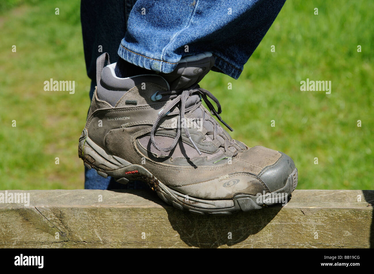 Mans walking shoe boot resting on a countryside stile Stock Photo Alamy