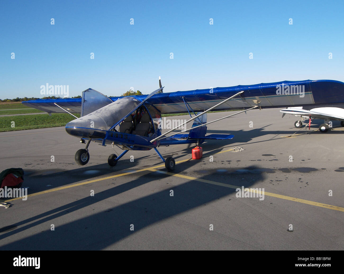 Light aircraft is faced toward sun to rid plane of slight frost on September morning. Stock Photo