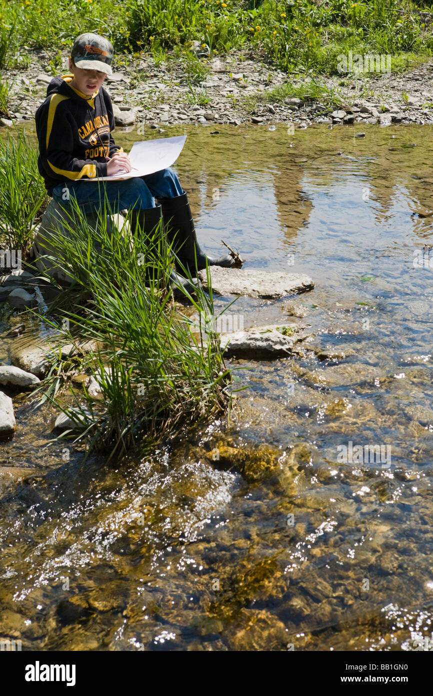 Fifth grade students schoolchildren studying ecology of a stream in Montgomery County upstate New York Stock Photo