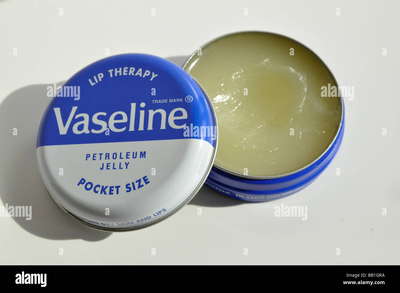 A small round tin of Vaseline, opened and used. Stock Photo