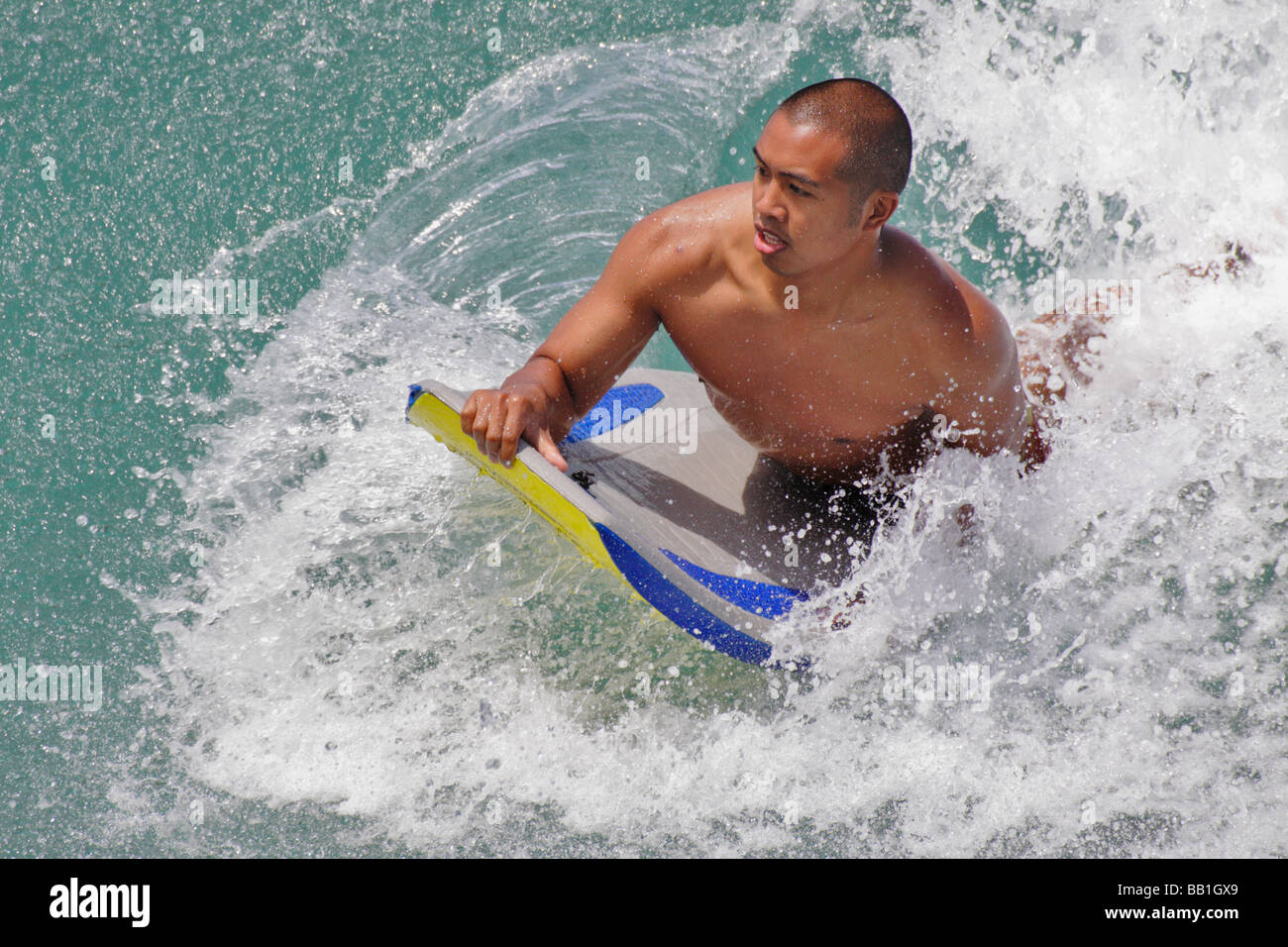 Boogie boarder riding a wave off Kapahulu Groin Waikiki Oahu USA Stock