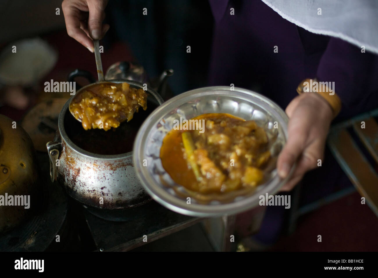 Widow serving a meal, Poultry Development for Women Project, Kabul, Afghanistan. Stock Photo