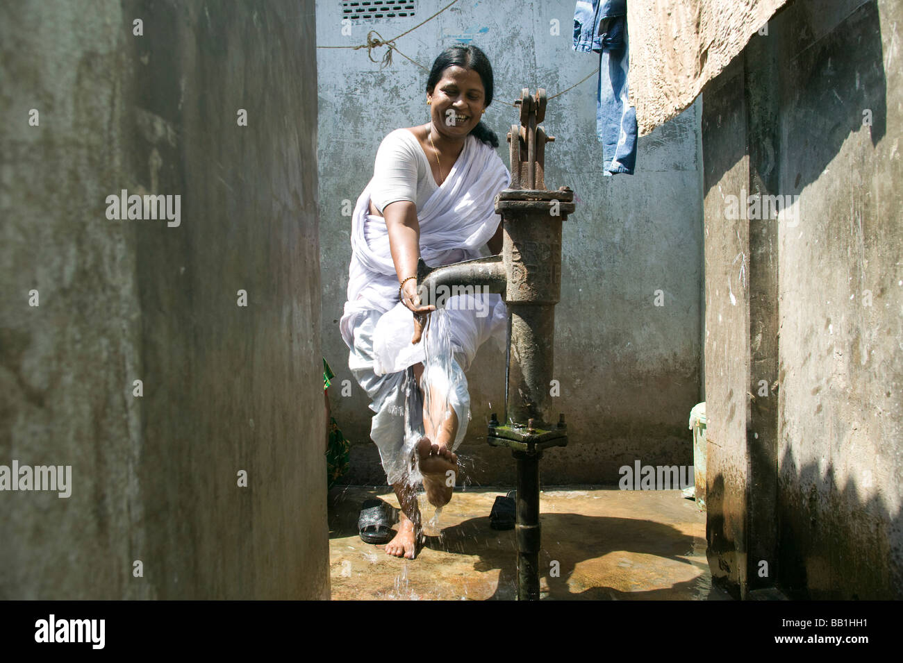 Leader for women's rights washing her feet in brothel, Tangail, Bangladesh. Stock Photo