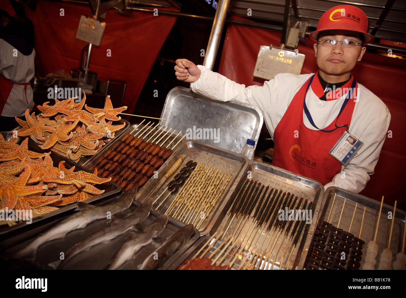 Man selling novelty foods at the night market in Beijing Stock Photo