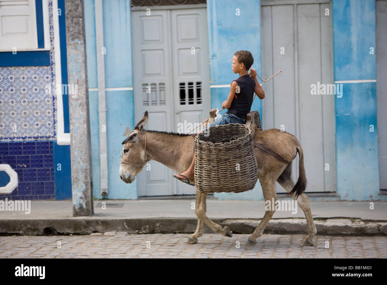A boy rides his burro through the colorful colonial town of Cachoeira ...