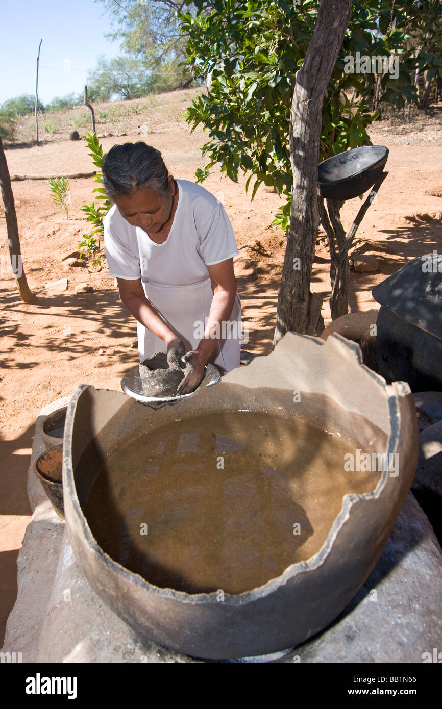 Native woman makes pottery in Mayo village of Capomos outside El Fuerte in the state of Sinaloa Mexico. Stock Photo
