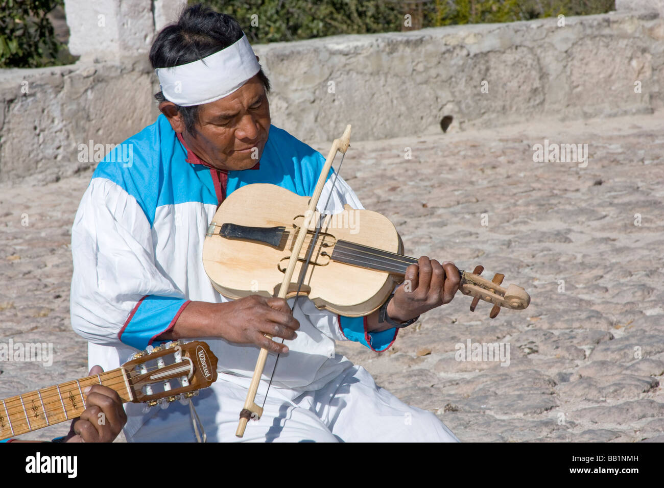 Tarahumara native Indian plays fiddle in performance for tourists in