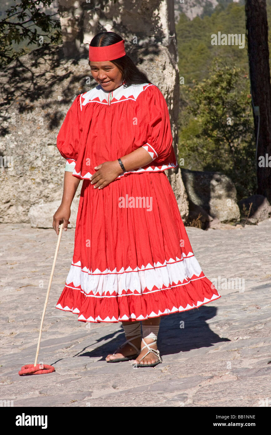 Native woman wearing hurache sandal of leather thongs with car tires for soles demonstrates ball race in Copper Canyon, Mexico Stock Photo