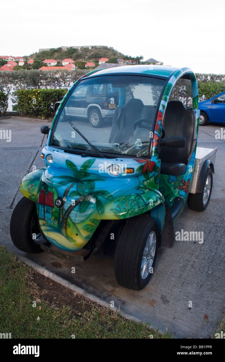 Electric car with tropical beach and palm tree paintwork parked Gustavia St Barts Stock Photo