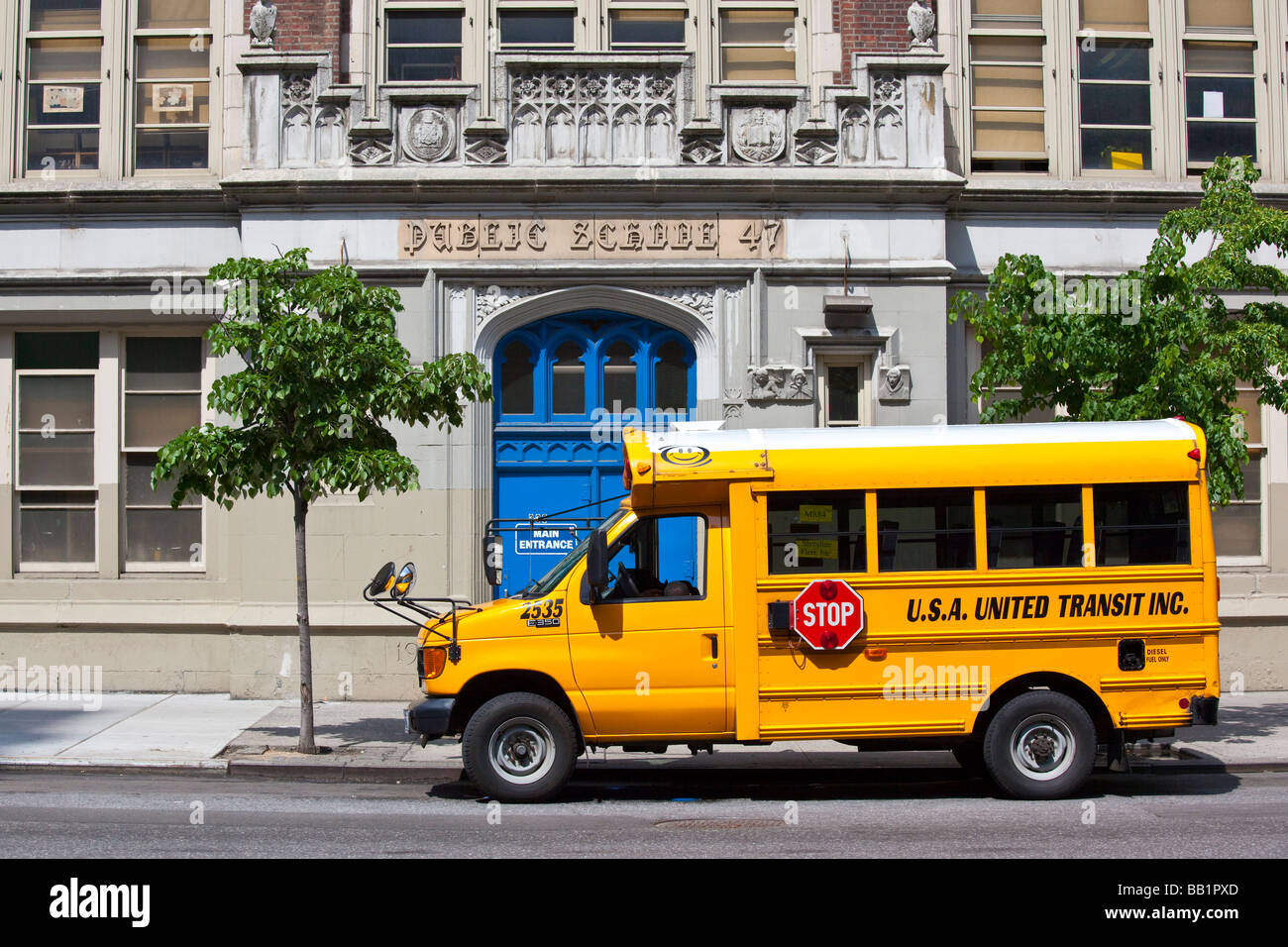 Public School and Yellow School Bus in New York City Stock Photo