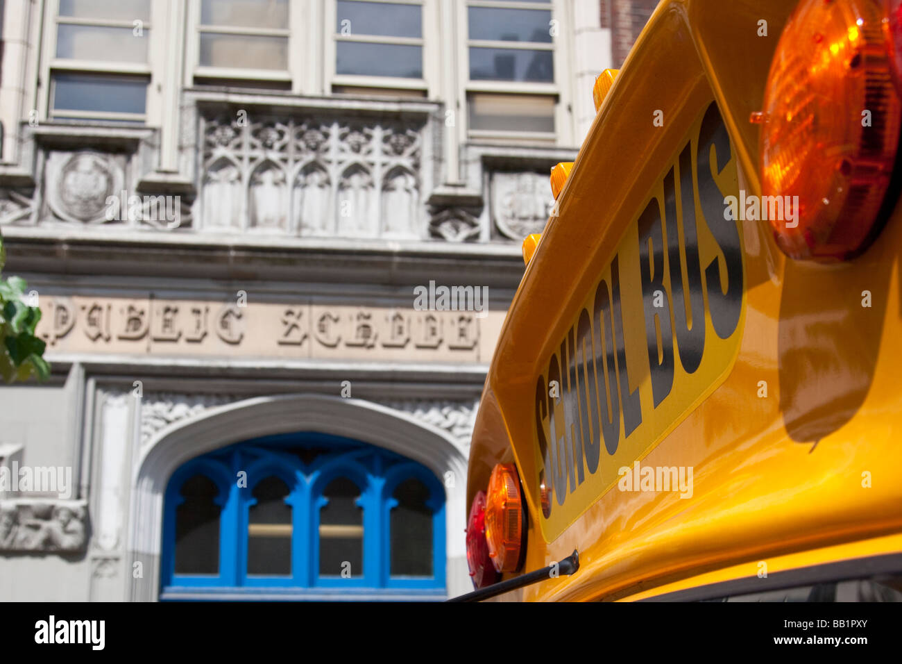 Public School and Yellow School Bus in New York City Stock Photo