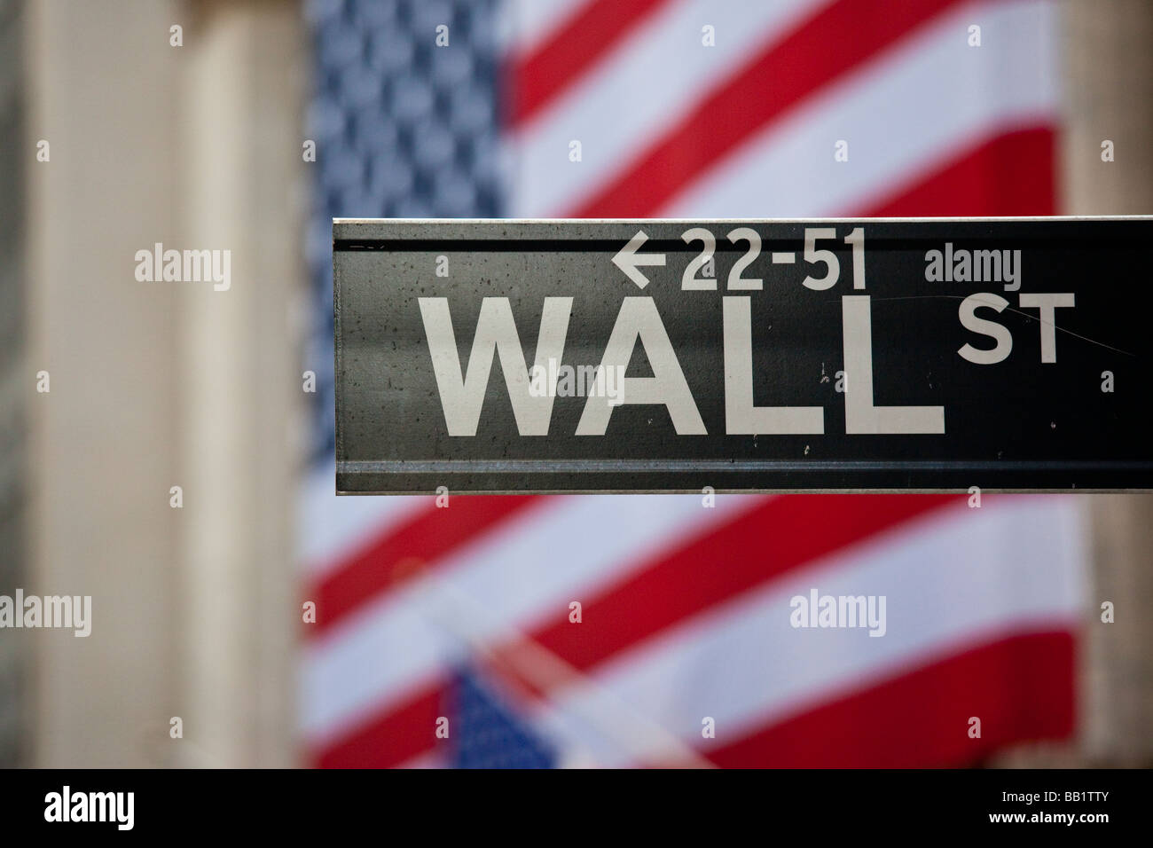 Wall Street Sign in front of the New York Stock Exchange Stock Photo