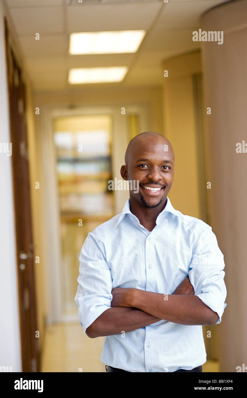 Portrait of a businessman with rolled up sleeves in an office. Pretoria, South Africa Stock Photo