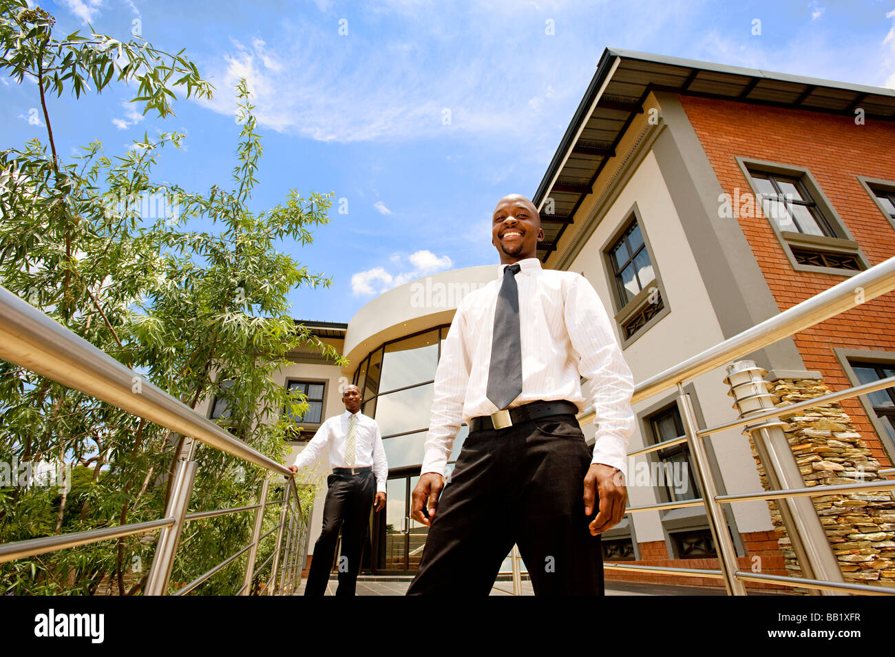 Two businessmen stand outside offices. Pretoria, South Africa Stock