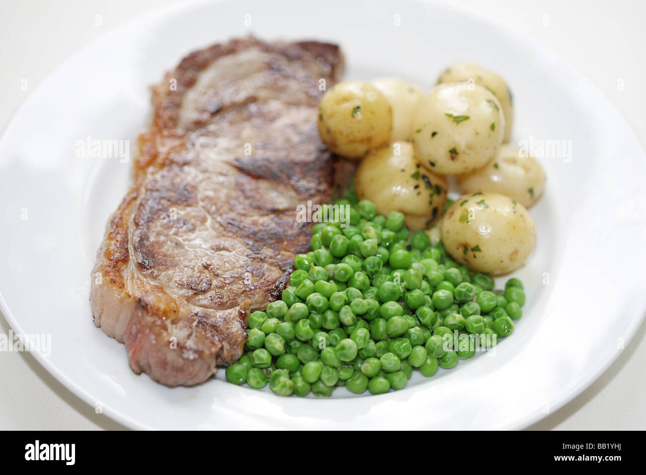 Sirloin Steak with Potatoes and Peas Stock Photo Alamy
