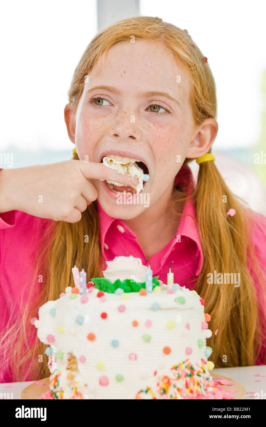 Girl eating birthday cake Stock Photo Alamy