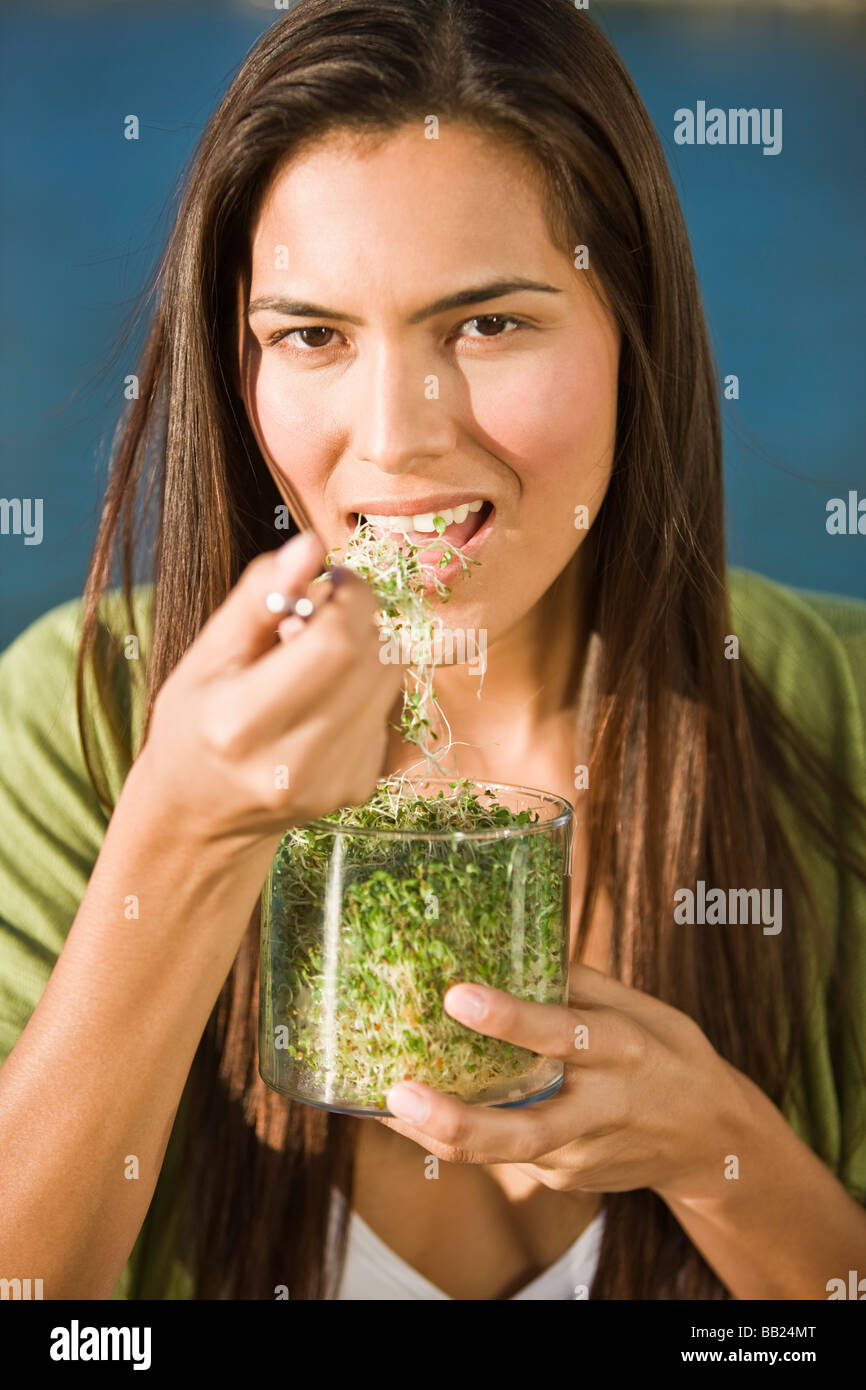 Portrait of a woman eating bean sprouts Stock Photo Alamy
