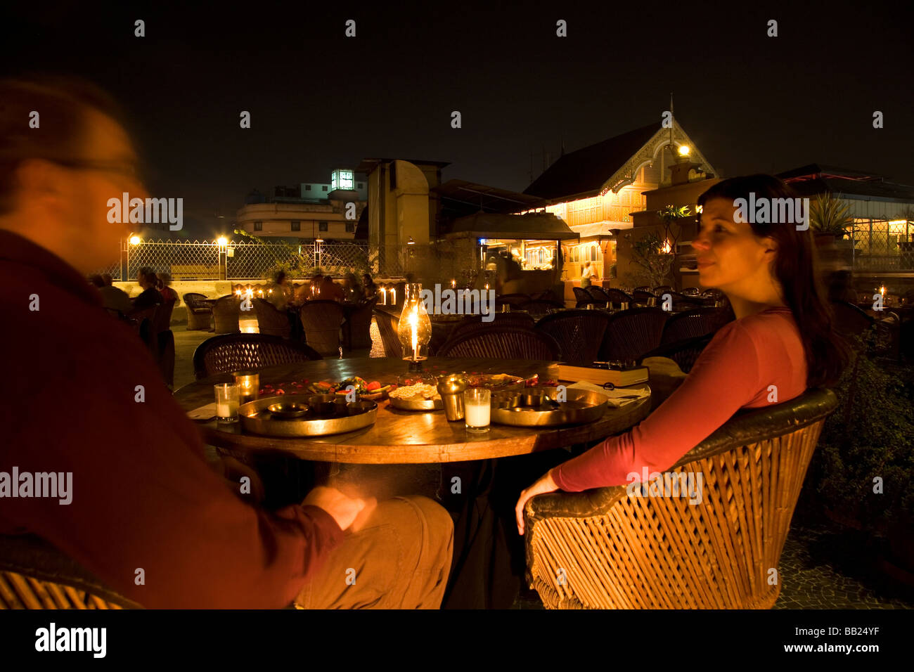 A western couple dine together on the rooftop terrace of the House of MG in the heart of the old city of Ahmedabad, Gujarat. Stock Photo