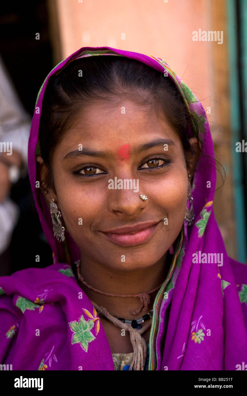 A young tribal woman in the Gujarati city of Rajkot, India. The woman wears a nose stud and a colourful headscarf. Stock Photo