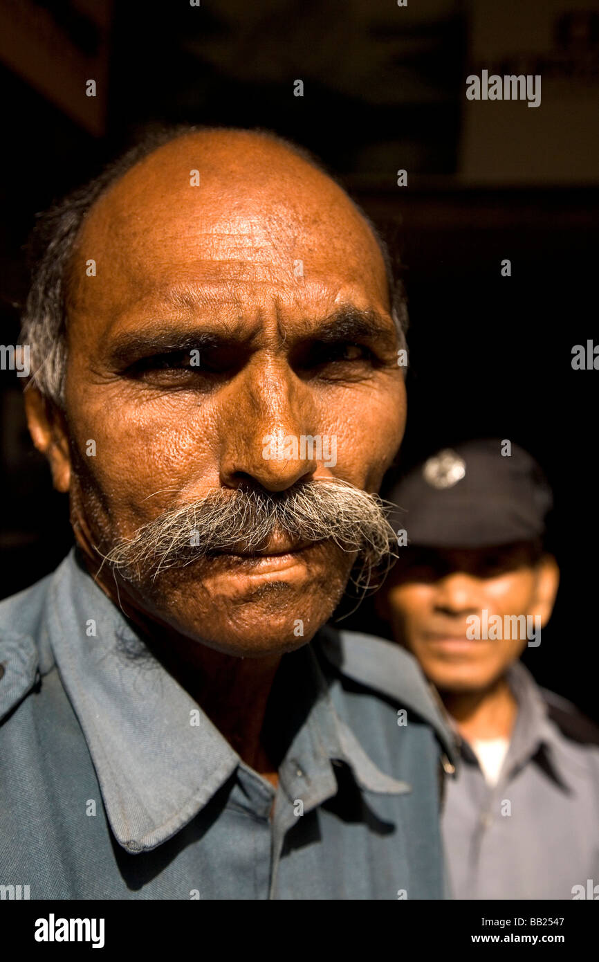 A security guard stands watchful in the Gujarati city of Rajkot, India. Stock Photo