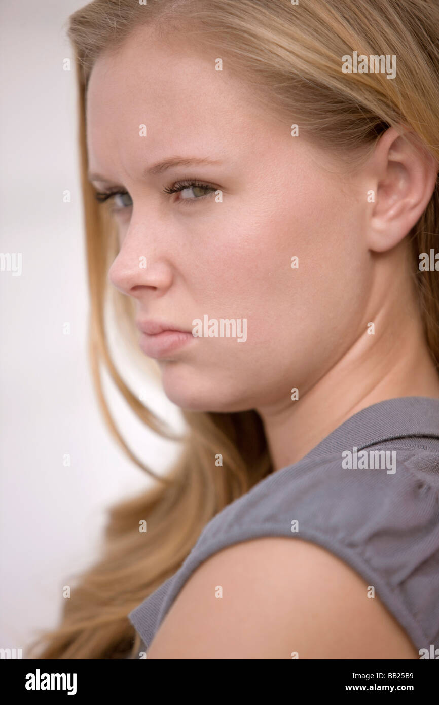 Portrait of a woman looking annoyed Stock Photo - Alamy