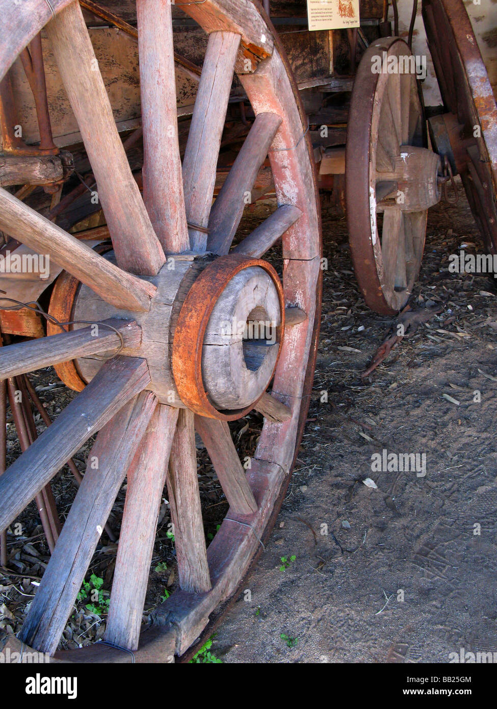 Wood and metal spoked wheels of  Two Horse Buggy in Buggy Shed of Telegraph Station. This is the birthplace of Alice Springs. Stock Photo