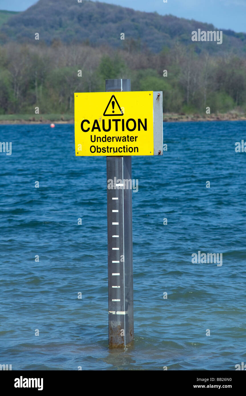 Caution Underwater obstruction sign in reservoir Derbyshire Peak
