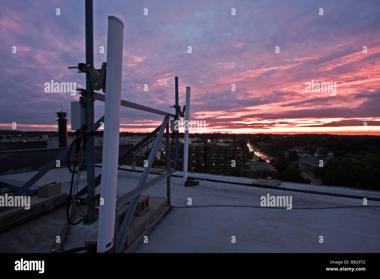 Cellular antennas installed on the rooftop seen during sunset Stock Photo