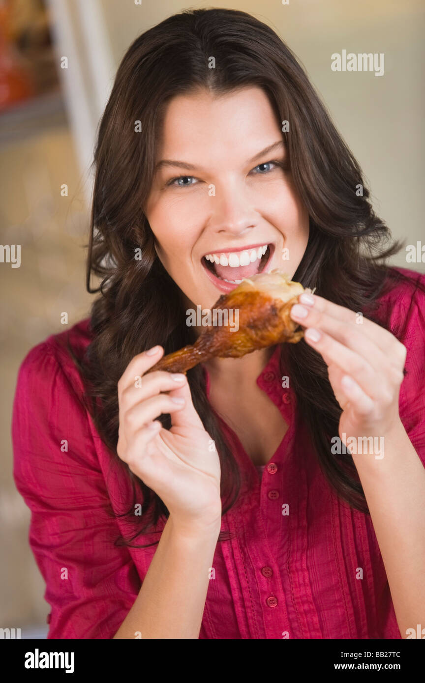 Woman eating chicken Stock Photo Alamy